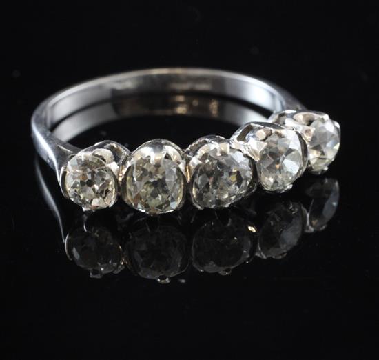 An 18ct white gold and graduated five stone diamond half hoop ring, size U.